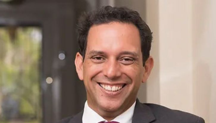 Photo of Chris Gambian (he/him).