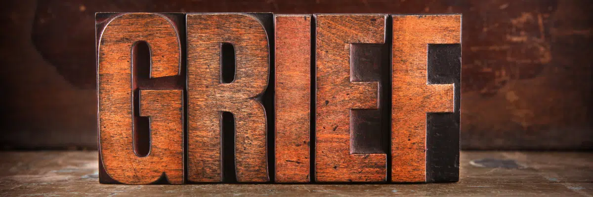 Grief spelled out in big wooden letters