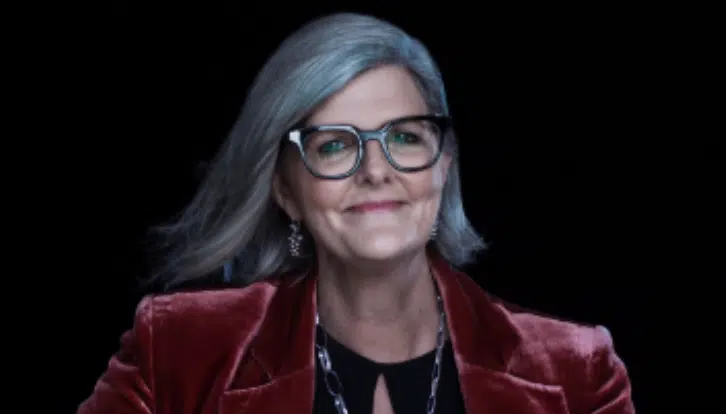 Grey hair, black glass, pink lipstick, red coat and black top