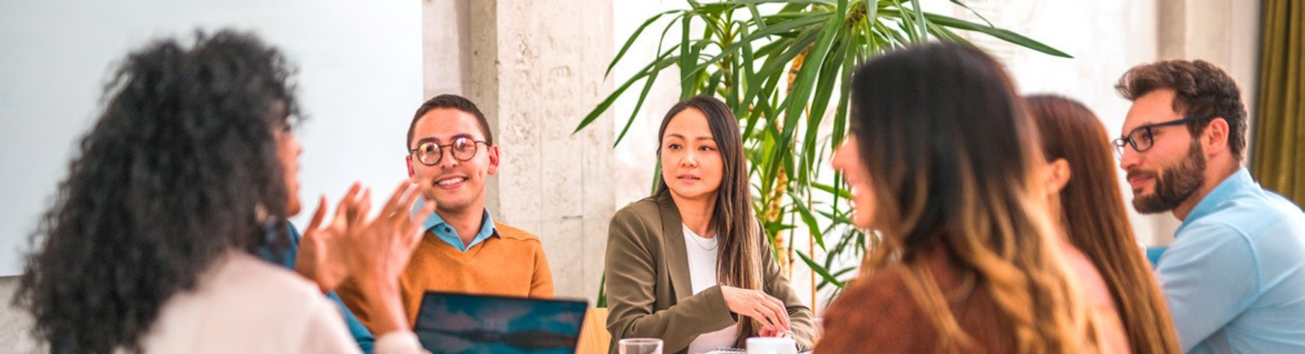 Group of smiling workers in a relaxed meeting.